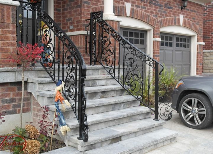 Exterior wrought iron railing on stone steps