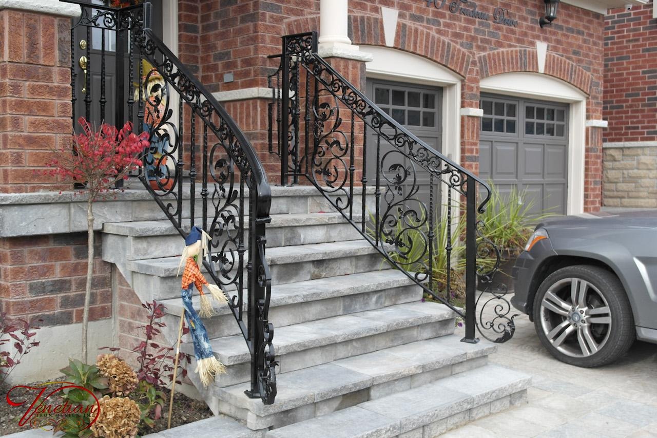 Exterior wrought iron railing on stone steps