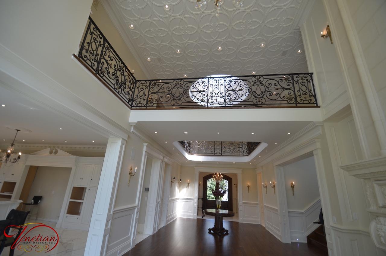 Ornate iron balcony railing on a stone facade